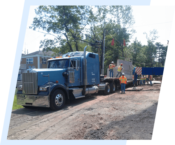 A large blue truck is parked on the side of the road.