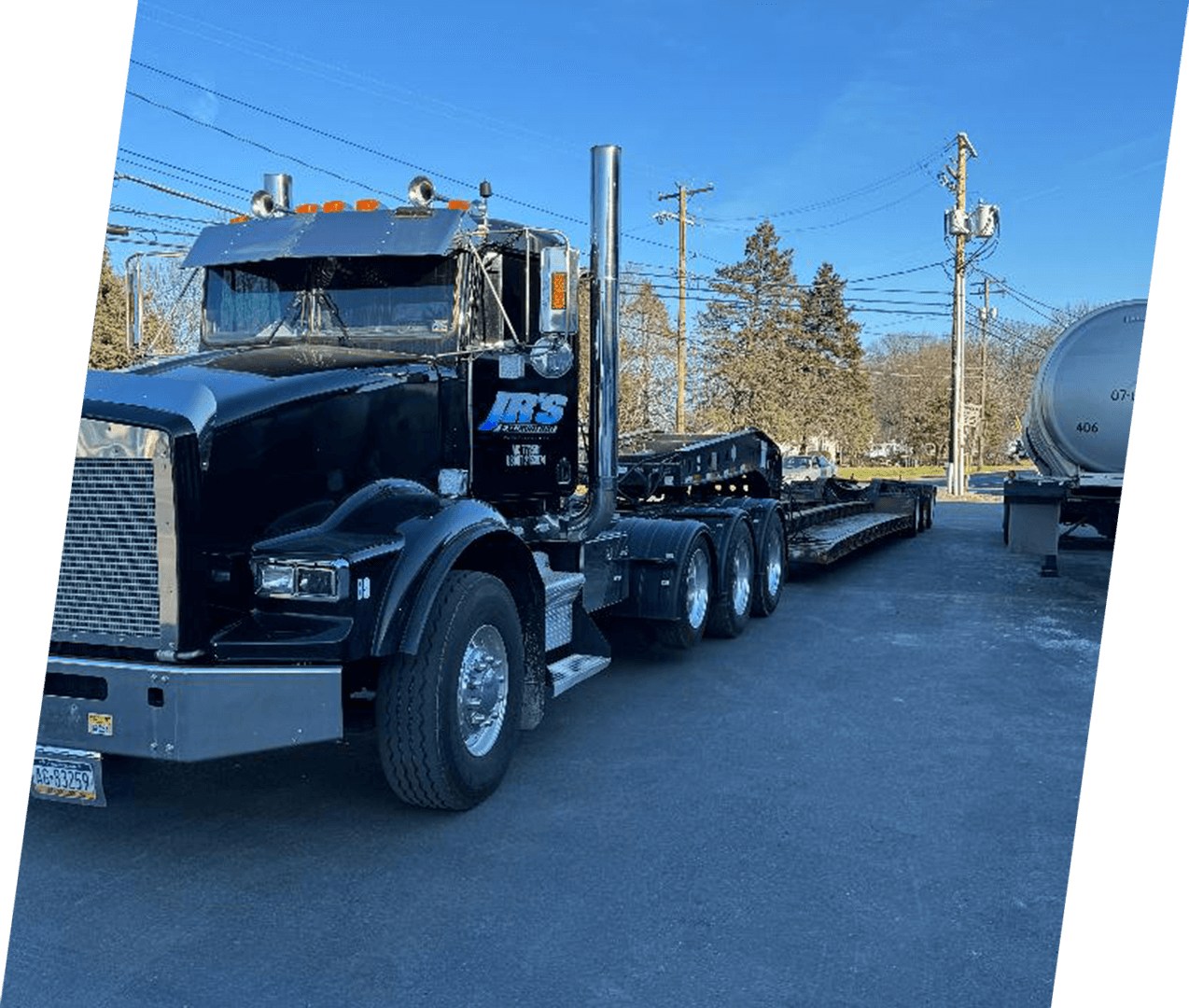 A black truck is parked on the side of the road.