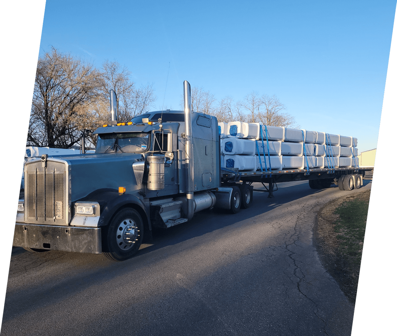 A semi truck with its trailer loaded down.