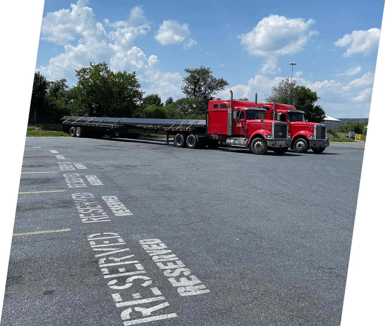 A red truck is parked in the parking lot