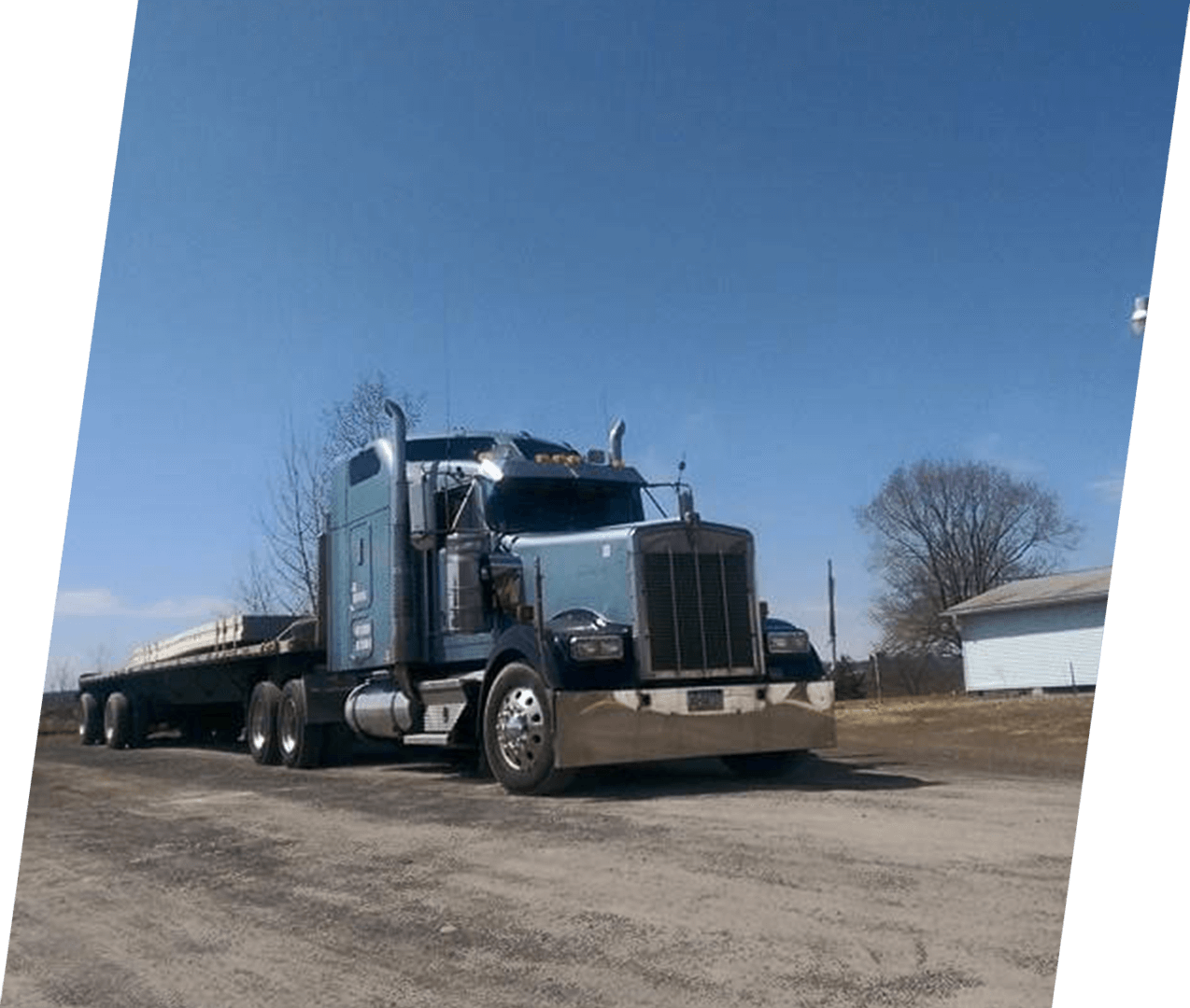 A semi truck is parked on the side of the road.