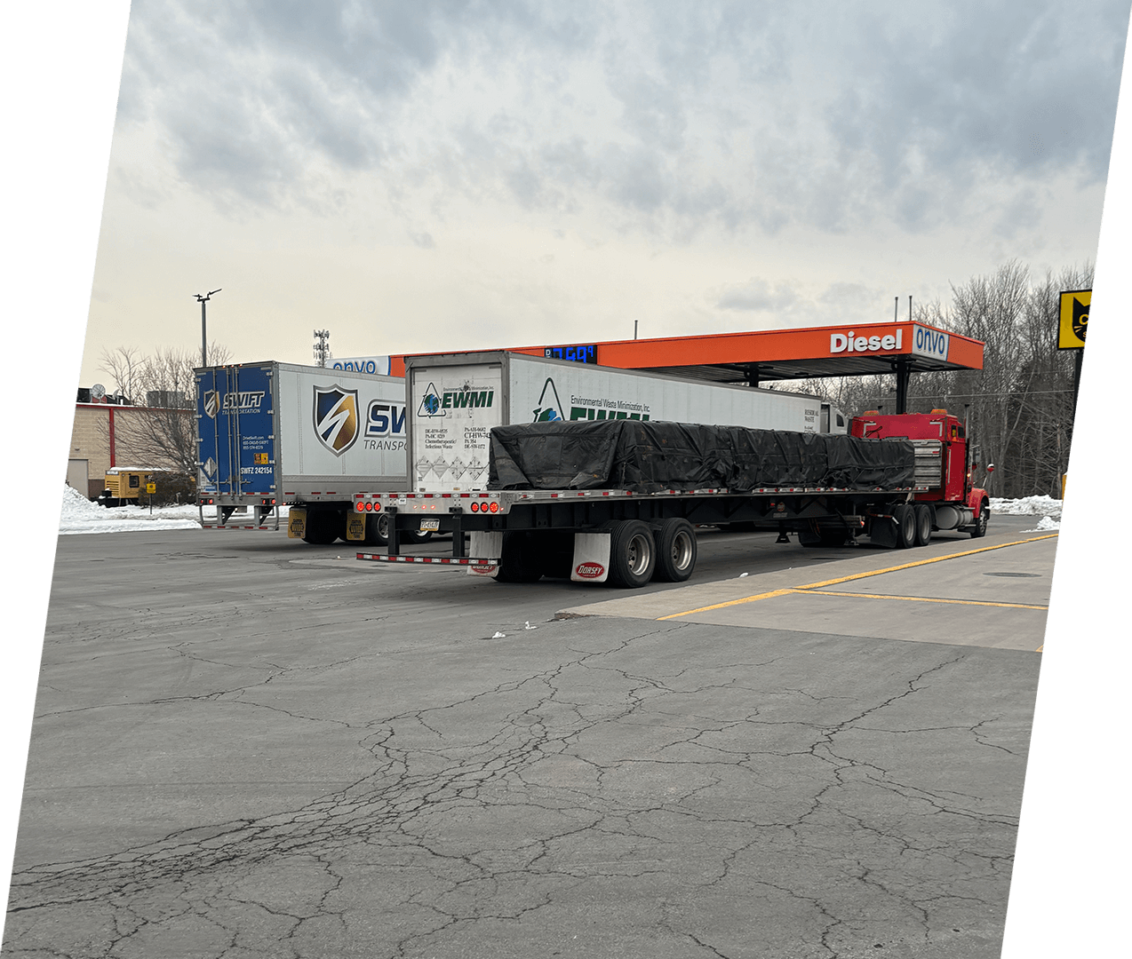 A truck parked in the lot with two trailers.