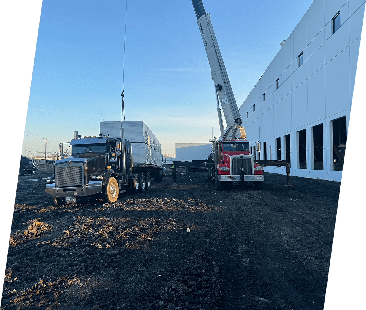 A truck is parked in front of a building.