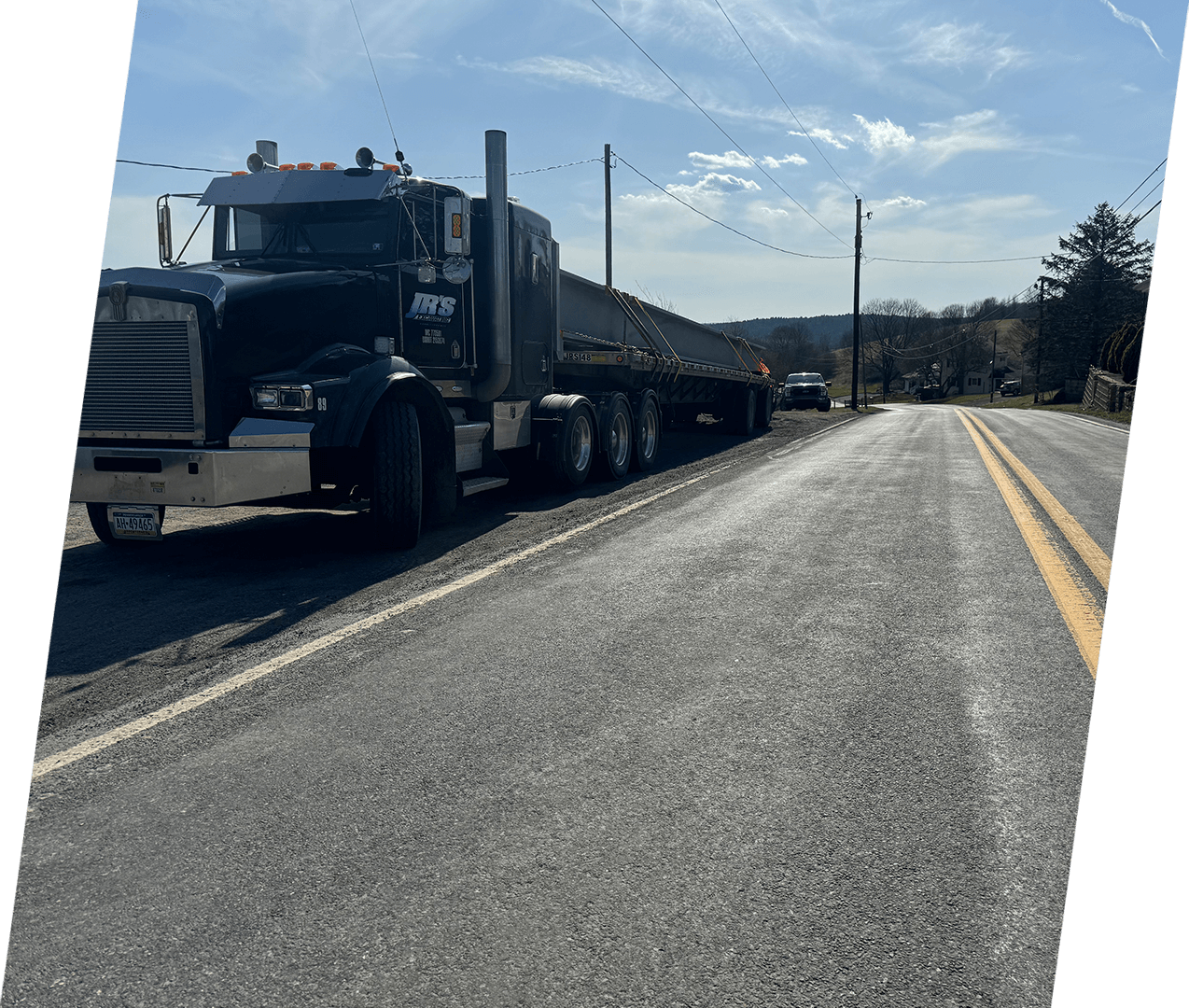 A large truck is driving down the road.