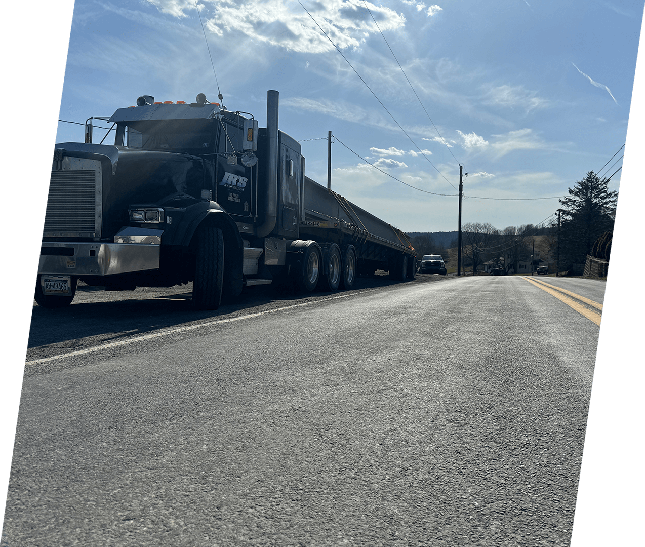 A large truck is driving down the road.