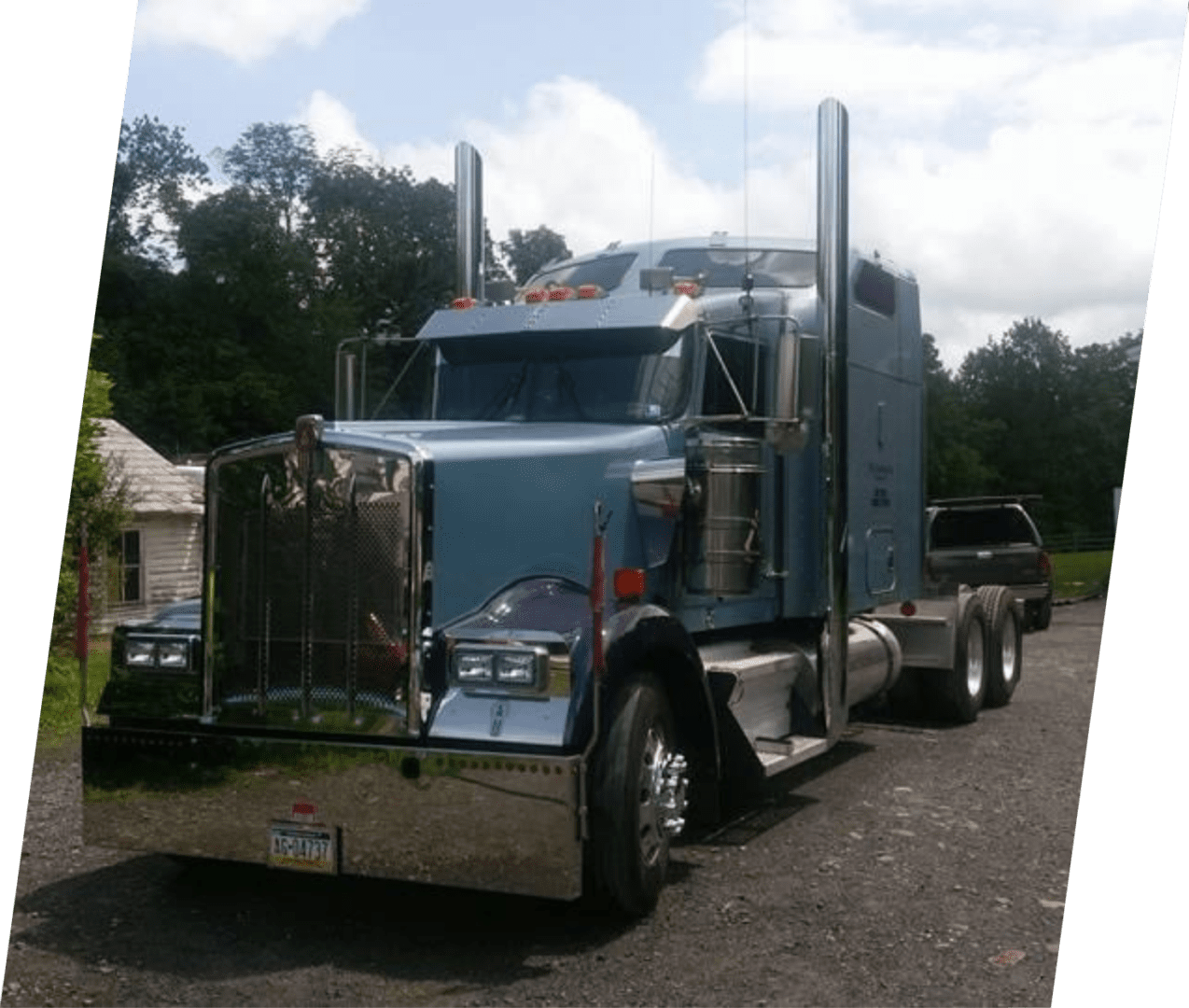 A large blue truck parked on the side of a road.