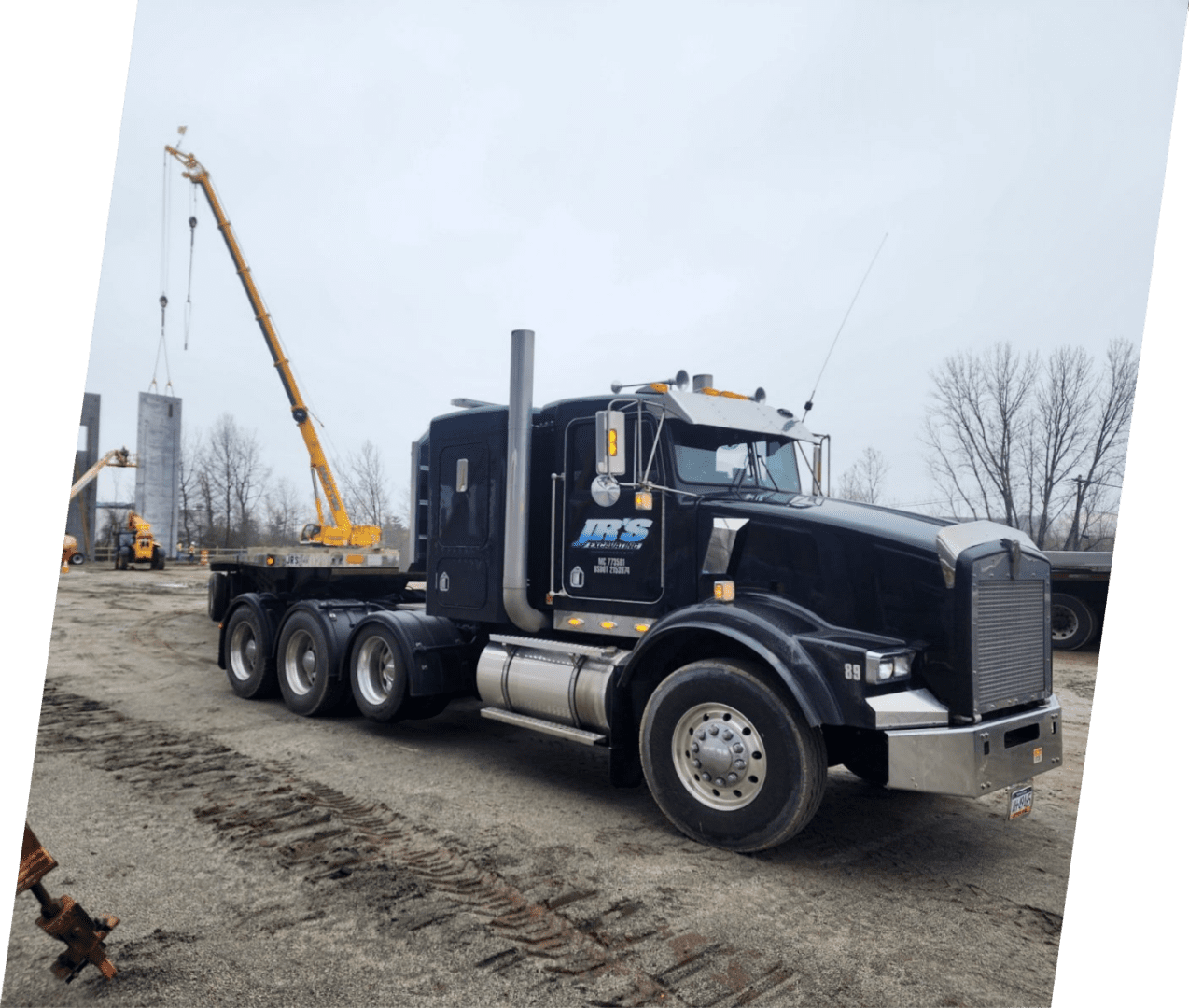 A black truck with a crane on the back