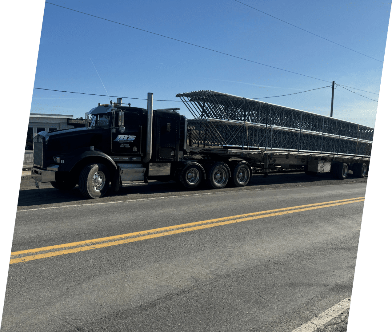 A large truck is driving down the street.