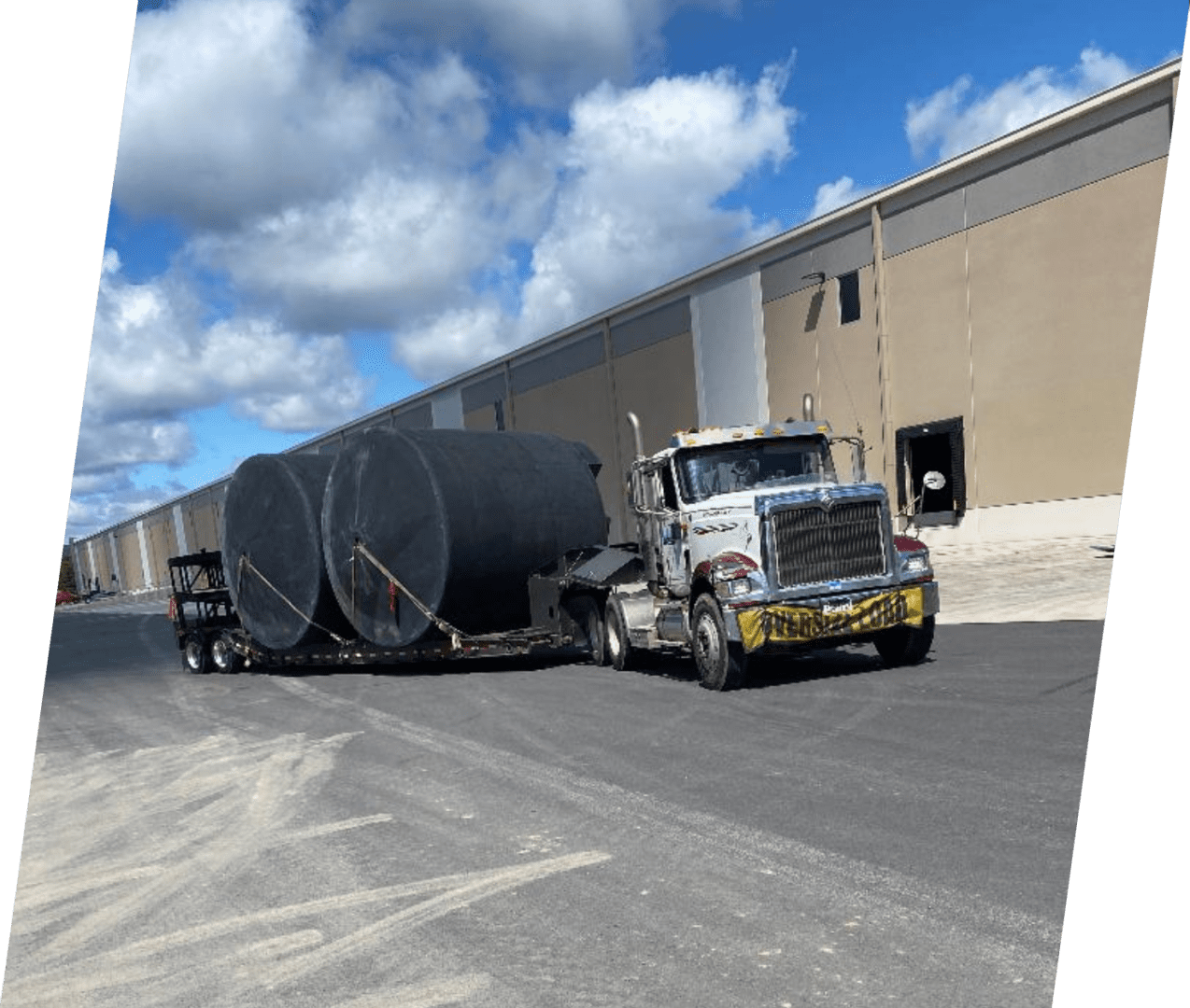 A large truck is pulling a trailer behind it.