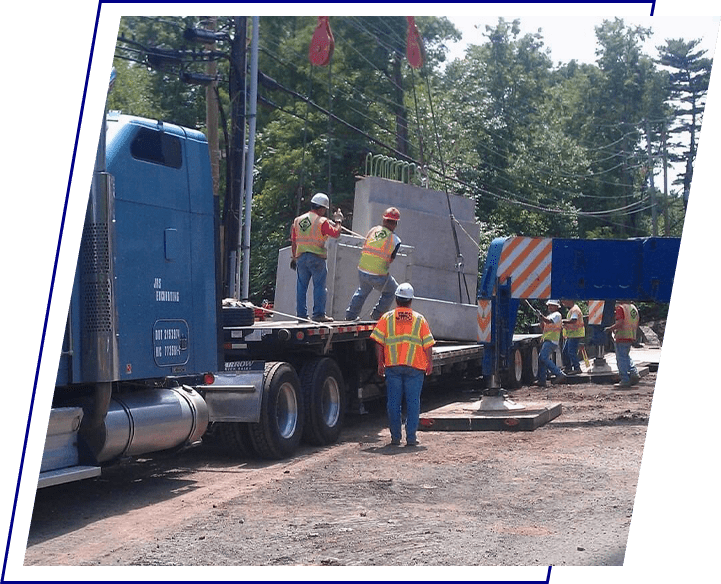 A group of construction workers standing on the side of a truck.