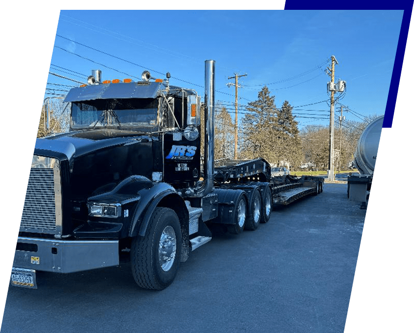 A black truck is parked on the side of the road.