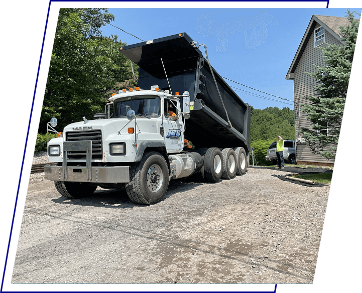 A dump truck is parked on the side of a road.